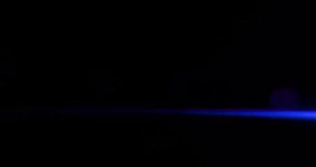 Anamorphic lens flare overlay on black background. Bokeh Light Leak Spherical Optical abstract visual effect. High quality 4k footage