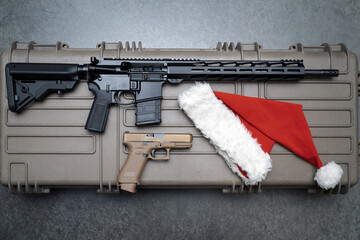 Christmas and guns, ar 15 rifle and pistol with santa hat.