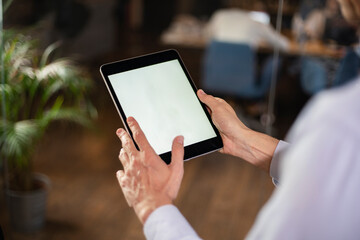 Close up of man using digital tablet.