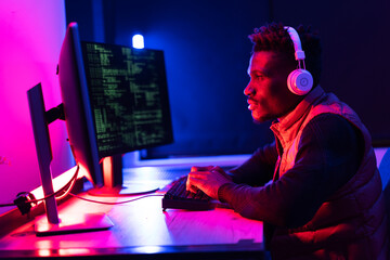 Software developer coding on his computer. Coding and hacking concept.