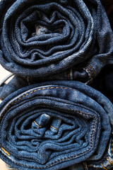 Jeans rolled up and stacked. Concept of the trading industry, sales.