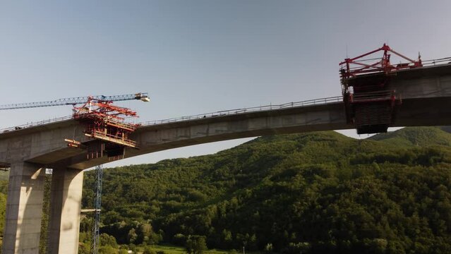 Highway bridge under construction. Aerial view of nes road. Freeway being built on a mountain terrain..