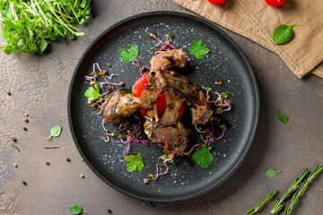 Rack of lamb on black plate top view © Алиса Королевская