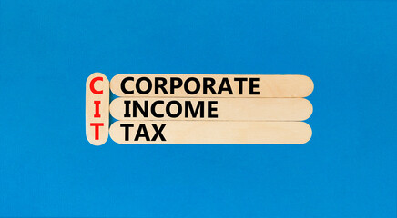 CIT corporate income tax symbol. Concept words CIT corporate income tax on wooden sticks on a beautiful blue table blue background. Business and CIT corporate income tax concept. Copy space.
