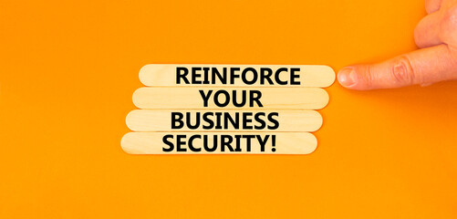 Reinforce your business security symbol. Concept word Reinforce your business security on sticks. Beautiful orange background. Business reinforce your business security concept. Copy space.