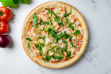 Pizza with arugula and shrimps with cheese and tomato sauce top view