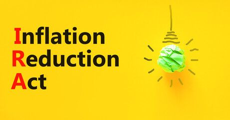 IRA inflation reduction act symbol. Concept words IRA inflation reduction act on yellow paper on...