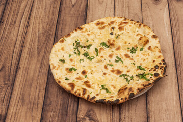 Naan is a flat bread, made from wheat flour and usually leavened. It is commonly consumed in various regions of Central Asia and South Asia