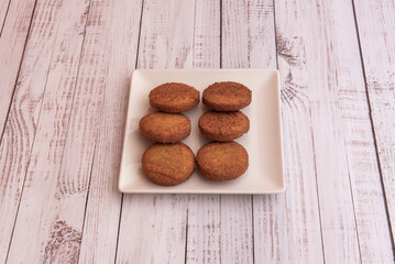 A tray of fruit falafel pills on a white table