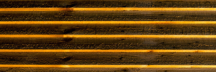 Background texture of new wooden fence in sunlight in panorama format