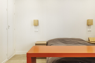 A double room with a double bed with wooden side tables and a built-in wardrobe with white doors