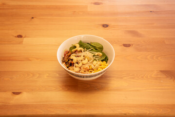 A wonderful bowl of vegan salad with bean sprouts, cashew nuts, corn and spinach