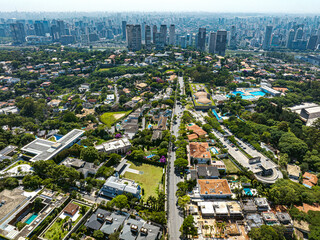 Aerial view of a luxury neighborhood with swimming pool and big mansions. City of Sao Paulo, Morumbi neighborhood, Doctor Alberto Penteado Avenue.