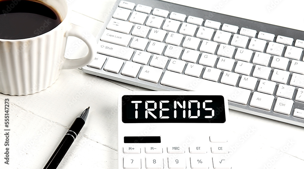 Poster trends text on calculator with keyboard and coffee