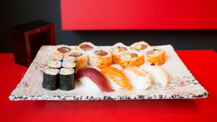 Set of sushi with variety of makis, nigiris and sashimi with fine fish like salmon and tuna.