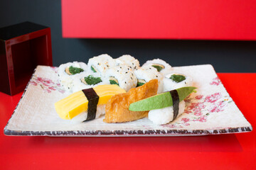 Set of sushi with variety of makis, nigiris and sashimi with fine fish like salmon and tuna.