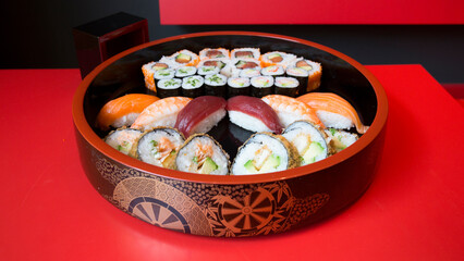 Set of sushi with variety of makis, nigiris and sashimi with fine fish like salmon and tuna.