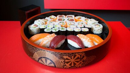 Set of sushi with variety of makis, nigiris and sashimi with fine fish like salmon and tuna.