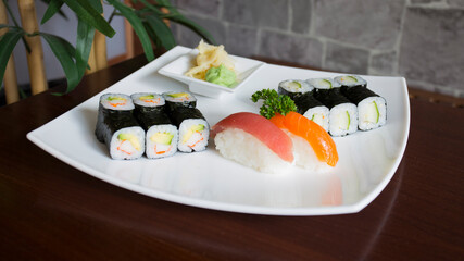 Set of sushi with variety of makis, nigiris and sashimi with fine fish like salmon and tuna.