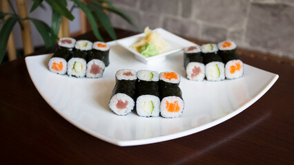 Set of sushi with variety of makis, nigiris and sashimi with fine fish like salmon and tuna.