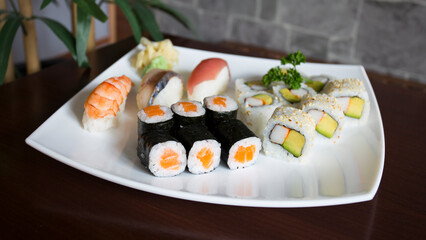 Set of sushi with variety of makis, nigiris and sashimi with fine fish like salmon and tuna.
