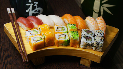 Set of sushi with variety of makis, nigiris and sashimi with fine fish like salmon and tuna.