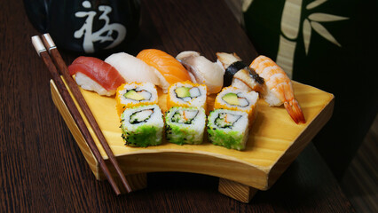 Set of sushi with variety of makis, nigiris and sashimi with fine fish like salmon and tuna.