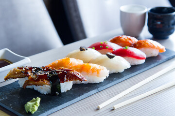Set of sushi with variety of nigiris with fine fish like salmon and tuna.