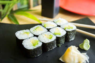 Vegan Maki sushi with rice and seaweed stuffed with vegetables and vegetarian ingredients.