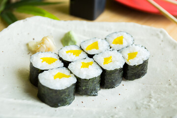 Vegan Maki sushi with rice and seaweed stuffed with vegetables and vegetarian ingredients.