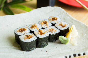 Vegan Maki sushi with rice and seaweed stuffed with vegetables and vegetarian ingredients.