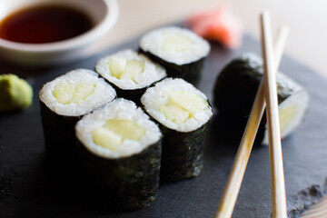 Vegan Maki sushi with rice and seaweed stuffed with vegetables and vegetarian ingredients.