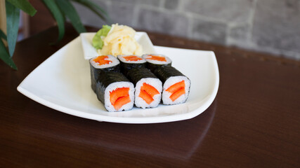 Vegan Maki sushi with rice and seaweed stuffed with vegetables and vegetarian ingredients.