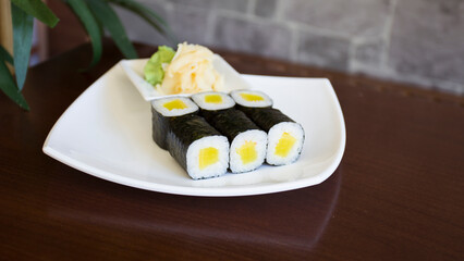 Vegan Maki sushi with rice and seaweed stuffed with vegetables and vegetarian ingredients.