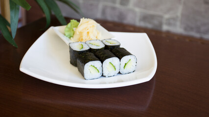 Vegan Maki sushi with rice and seaweed stuffed with vegetables and vegetarian ingredients.