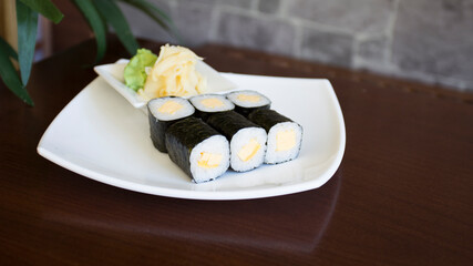 Vegan Maki sushi with rice and seaweed stuffed with vegetables and vegetarian ingredients.