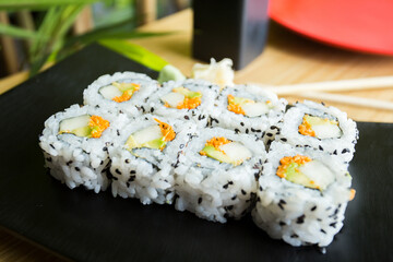 Vegan uramaki. Type of sushi covered with rice on the outside and filled with a combination of vegetables.
