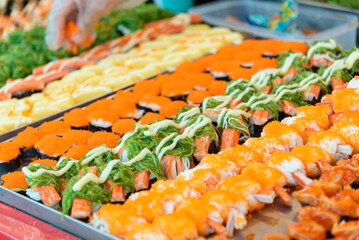 Closeup focus to row of sushi menu  in the tray