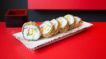 Chicken hot roll. Sushi roll stuffed with chicken and fried whole with breadcrumbs.