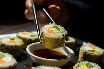 Vegan sushi hot roll. Sushi roll filled with vegetables and fried.