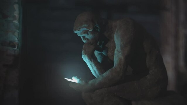 Thinker statue holding a smartphone. 3D animation of Auguste Rodin 100 year old sculpture.