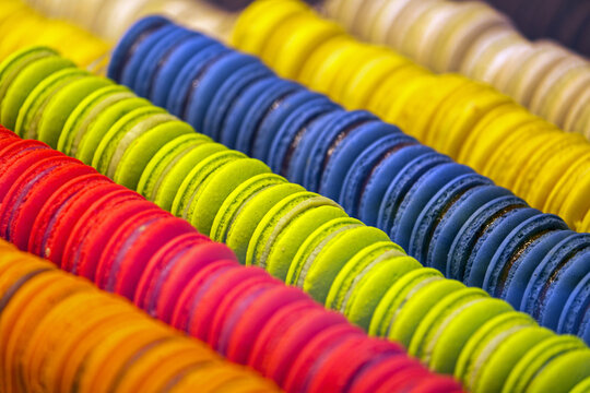Close-up of colourful macaroons all in a row in store showcase; Luxembourg City, Luxembourg