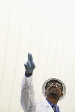 Scientist pointing towards a digester tank