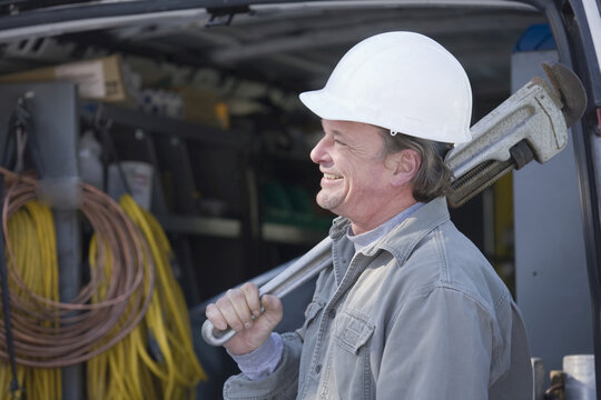 Plumber holding a pipe wrench