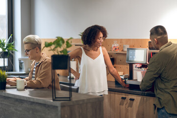 Three company employees in the office kitchen