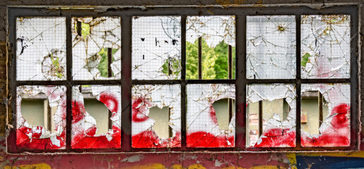 Vandalised window with in an abandoned airfield 