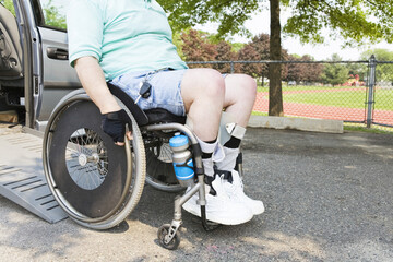 Man with Muscular Dystrophy in a wheelchair exiting an accessible van