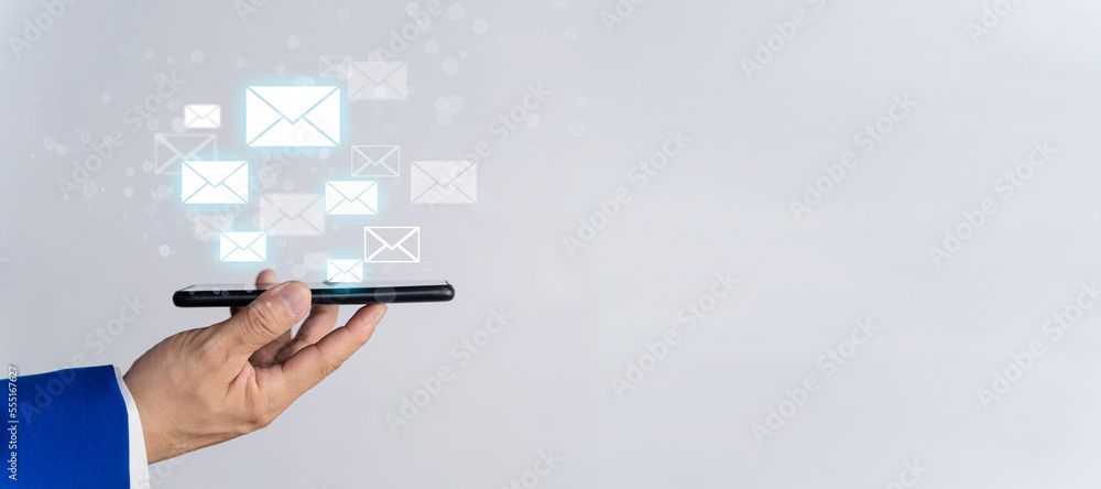Poster businessman sending email bulk mail touching smartphone with digital hologram email and message bann