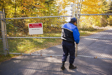 Security guard opening a gate