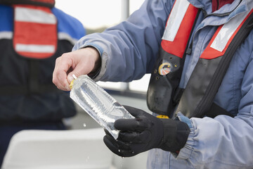 Scientist filling water sample in whirl pak